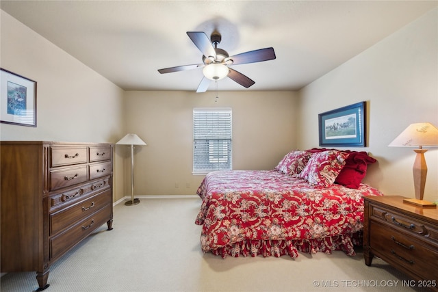 bedroom with ceiling fan and light colored carpet