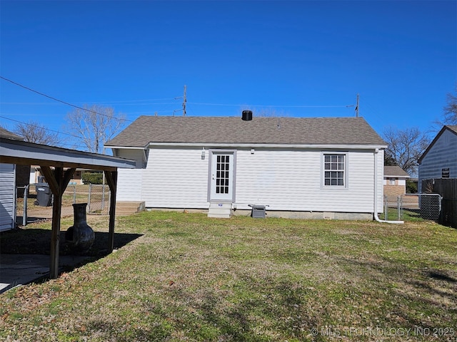 rear view of property featuring a yard