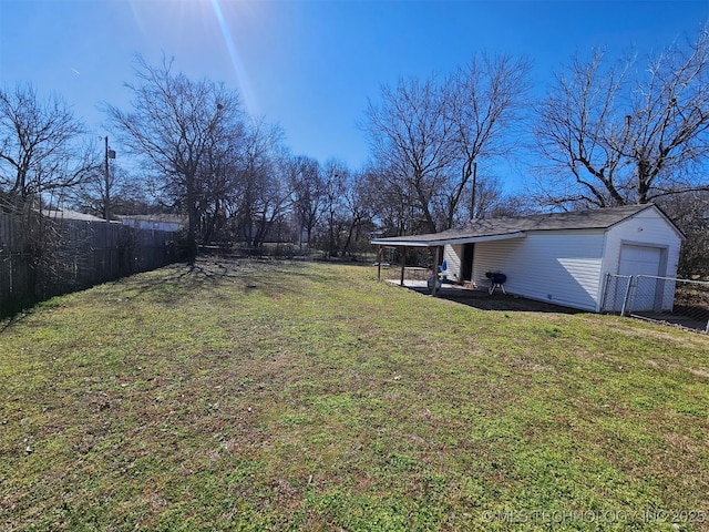 view of yard featuring a garage and an outdoor structure