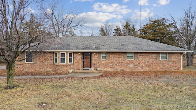 single story home featuring a front lawn and a patio