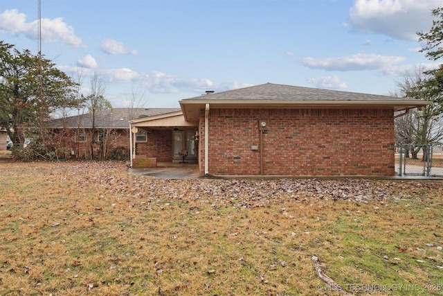 back of house featuring a yard and a patio area