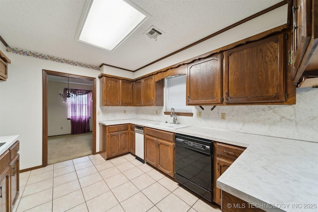 kitchen featuring sink, decorative light fixtures, a textured ceiling, dishwasher, and decorative backsplash