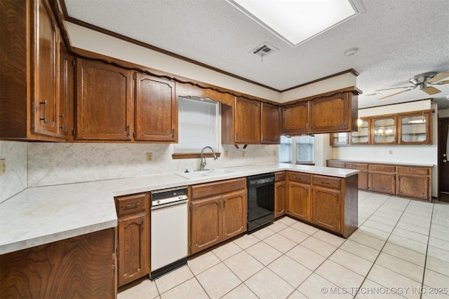 kitchen featuring black dishwasher, sink, kitchen peninsula, and a textured ceiling