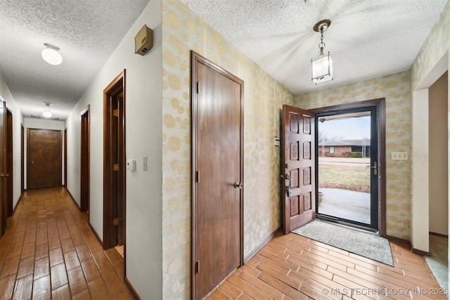 entryway with a textured ceiling