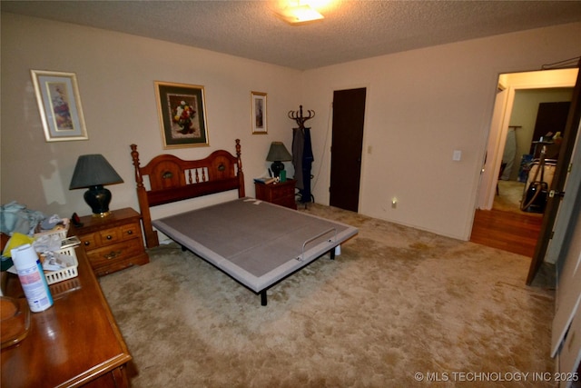 carpeted bedroom with a textured ceiling