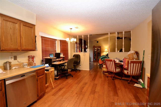 home office with light wood-type flooring, a textured ceiling, and a notable chandelier