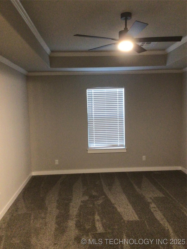 unfurnished room with crown molding, a raised ceiling, ceiling fan, and carpet