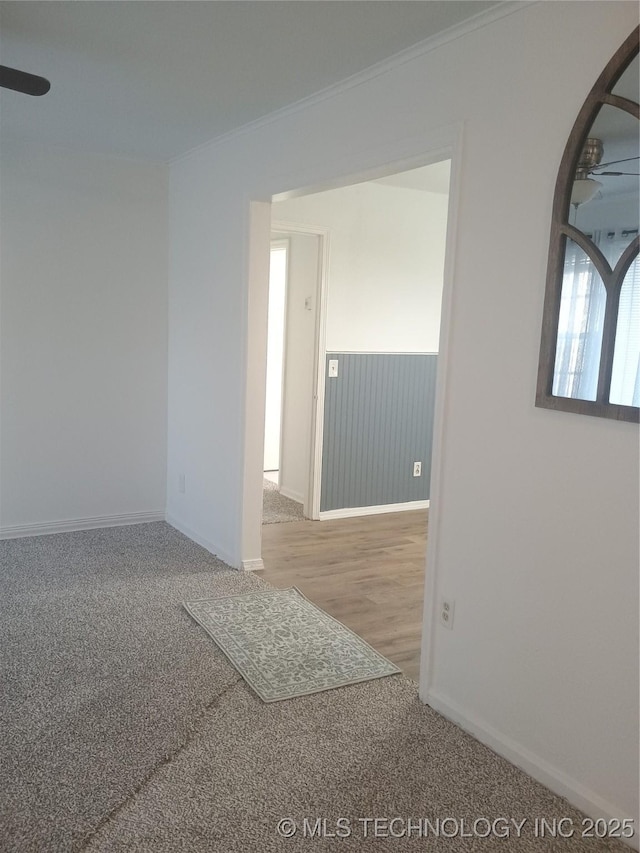 spare room featuring ornamental molding, carpet flooring, and ceiling fan