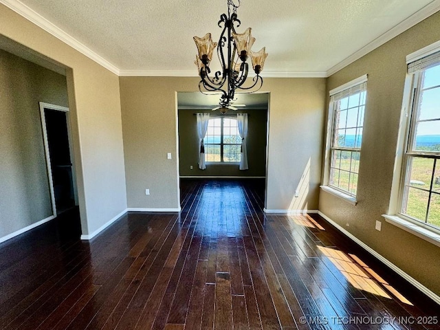 unfurnished dining area featuring ornamental molding, an inviting chandelier, a textured ceiling, and dark hardwood / wood-style flooring