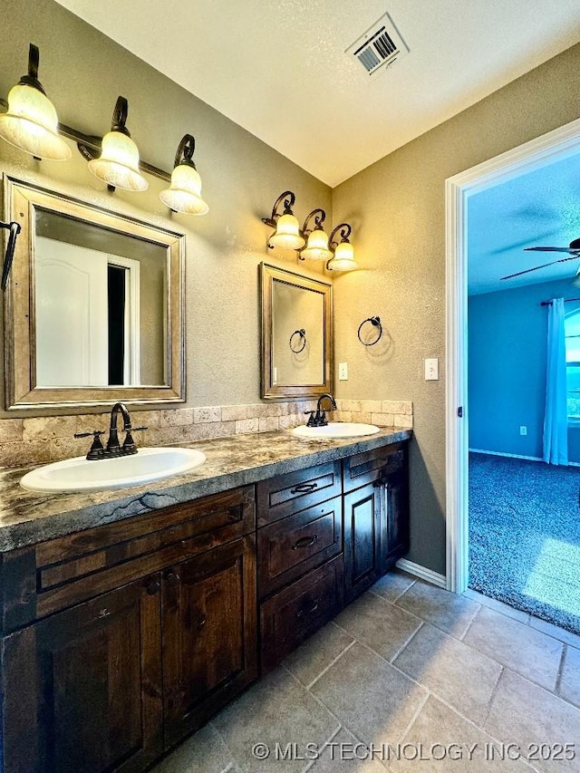 bathroom featuring ceiling fan and vanity