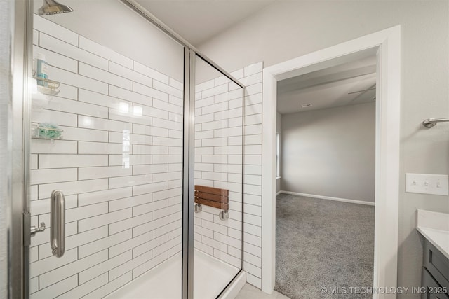 bathroom featuring vanity and a shower with door