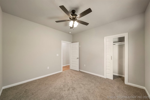 unfurnished bedroom featuring ceiling fan, a closet, and carpet