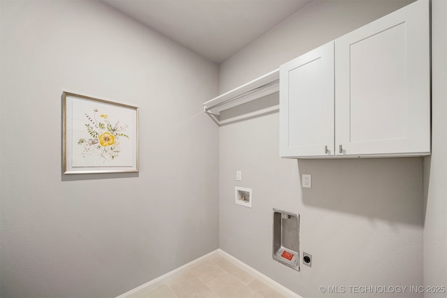 washroom featuring cabinets, electric dryer hookup, hookup for a washing machine, and light tile patterned floors