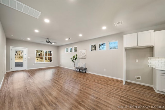 unfurnished living room featuring hardwood / wood-style flooring and ceiling fan