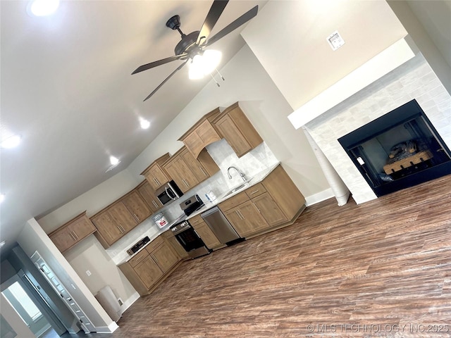 29910 94th Dr W Unit 1 & 2, Afton, OK 74331 - kitchen featuring dark wood-style flooring, a ceiling fan, a fireplace, stainless steel dishwasher, and range