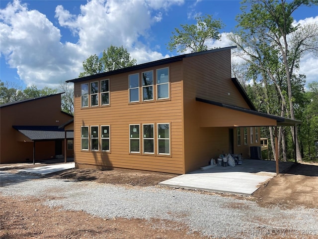 29910 94th Dr W Unit 1 & 2, Afton, OK 74331 - back of property with central AC, a patio area, and gravel driveway