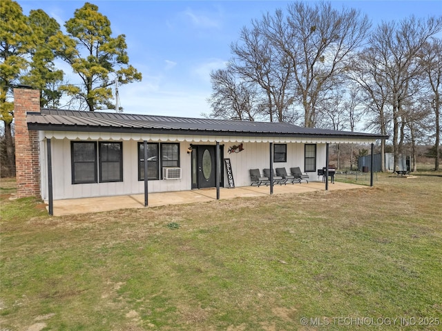 view of front facade with cooling unit, a patio area, and a front lawn