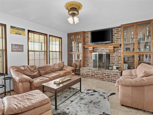 living room featuring light tile patterned flooring and a fireplace