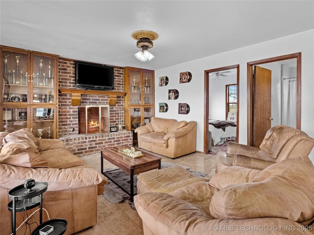 tiled living room featuring a brick fireplace