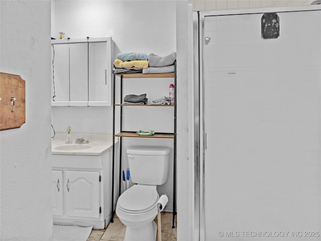 bathroom featuring vanity, toilet, and an enclosed shower