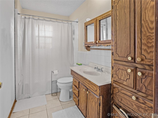 bathroom with toilet, a textured ceiling, vanity, a shower with shower curtain, and tile patterned flooring