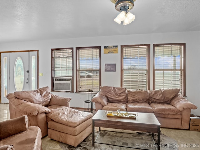 tiled living room with cooling unit and a textured ceiling