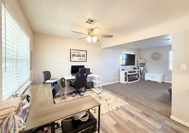 office area with ceiling fan and light hardwood / wood-style floors