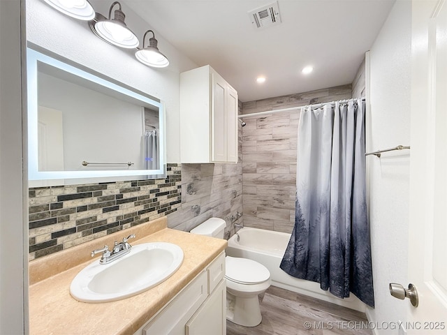 full bathroom featuring shower / tub combo with curtain, tasteful backsplash, wood-type flooring, vanity, and toilet