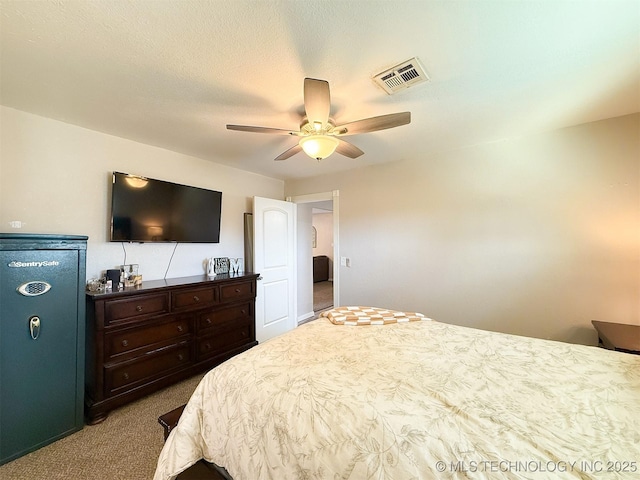 carpeted bedroom with a textured ceiling and ceiling fan