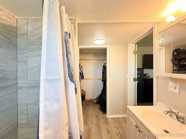 bathroom featuring vanity, hardwood / wood-style floors, and a textured ceiling