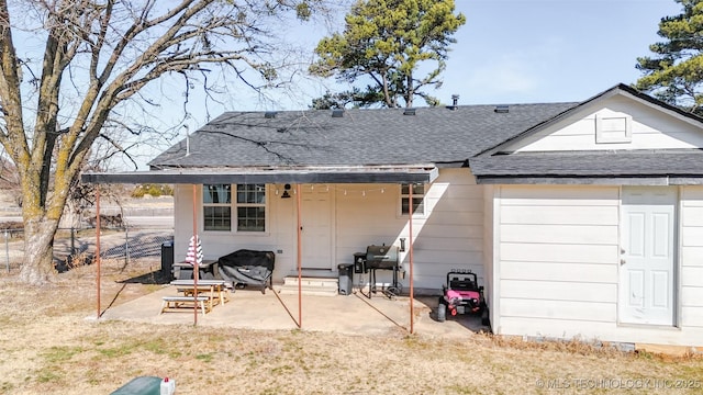 back of property with a patio