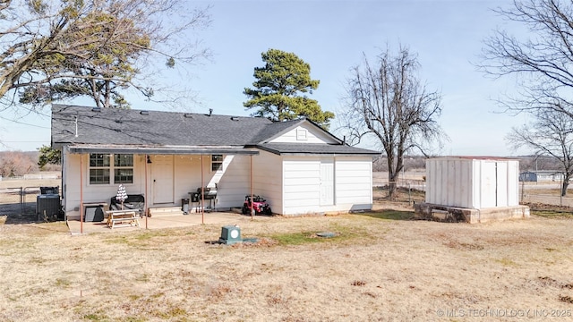 back of house featuring a yard, a patio area, a shed, and central air condition unit