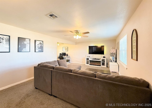 carpeted living room featuring ceiling fan