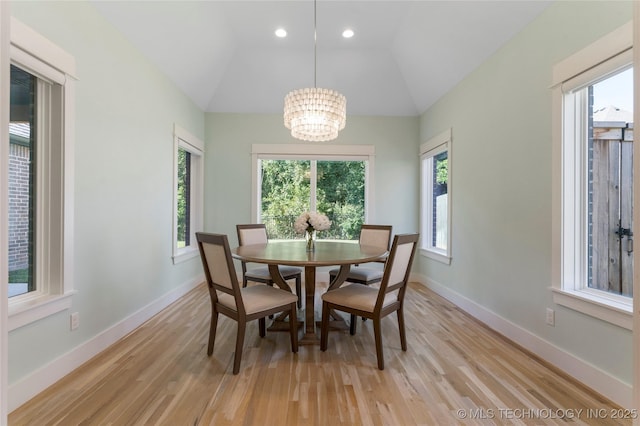 dining room featuring plenty of natural light, a chandelier, and light hardwood / wood-style floors