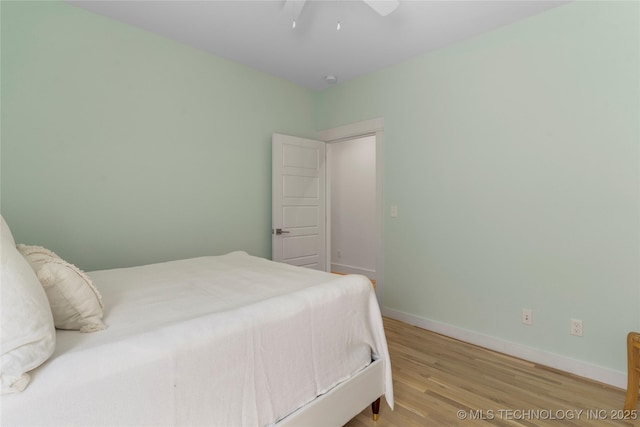 bedroom featuring ceiling fan and wood-type flooring