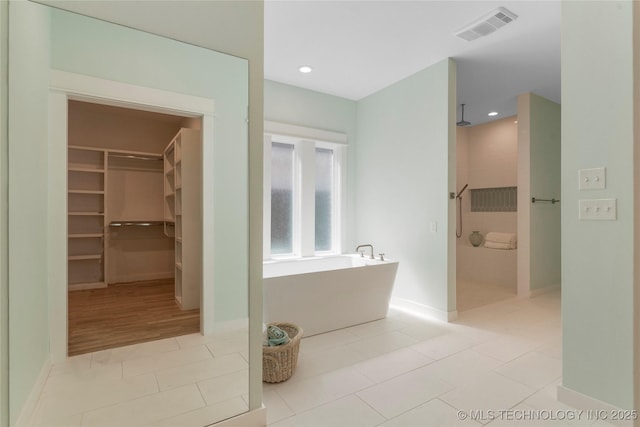 bathroom featuring shower with separate bathtub and tile patterned floors