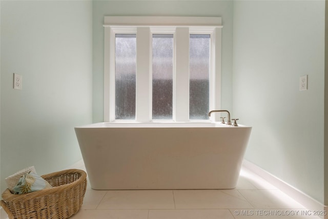 bathroom with tile patterned floors and a bathtub