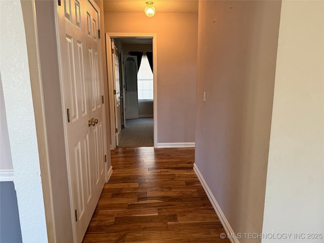 hall with dark wood-type flooring