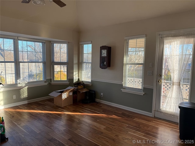 interior space featuring dark wood-type flooring and ceiling fan