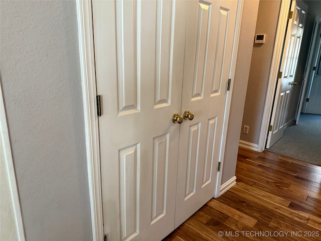 hallway with dark hardwood / wood-style floors