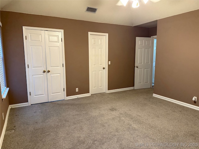 unfurnished bedroom with carpet flooring and a closet