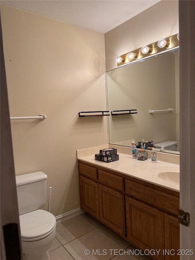 bathroom with vanity, tile patterned floors, and toilet