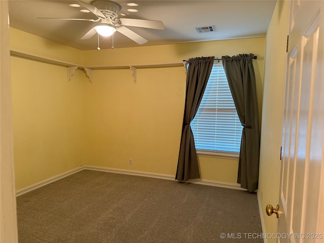 carpeted spare room featuring ceiling fan