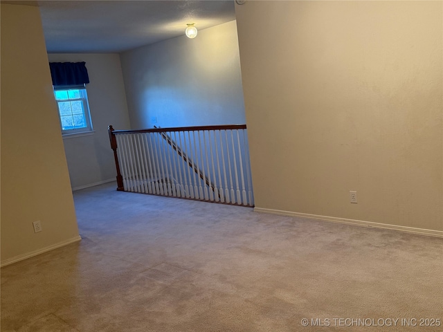 unfurnished room with light carpet