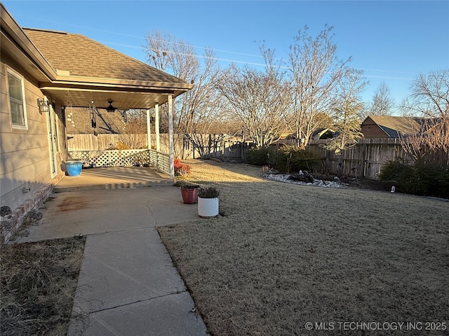 view of yard with ceiling fan and a patio area