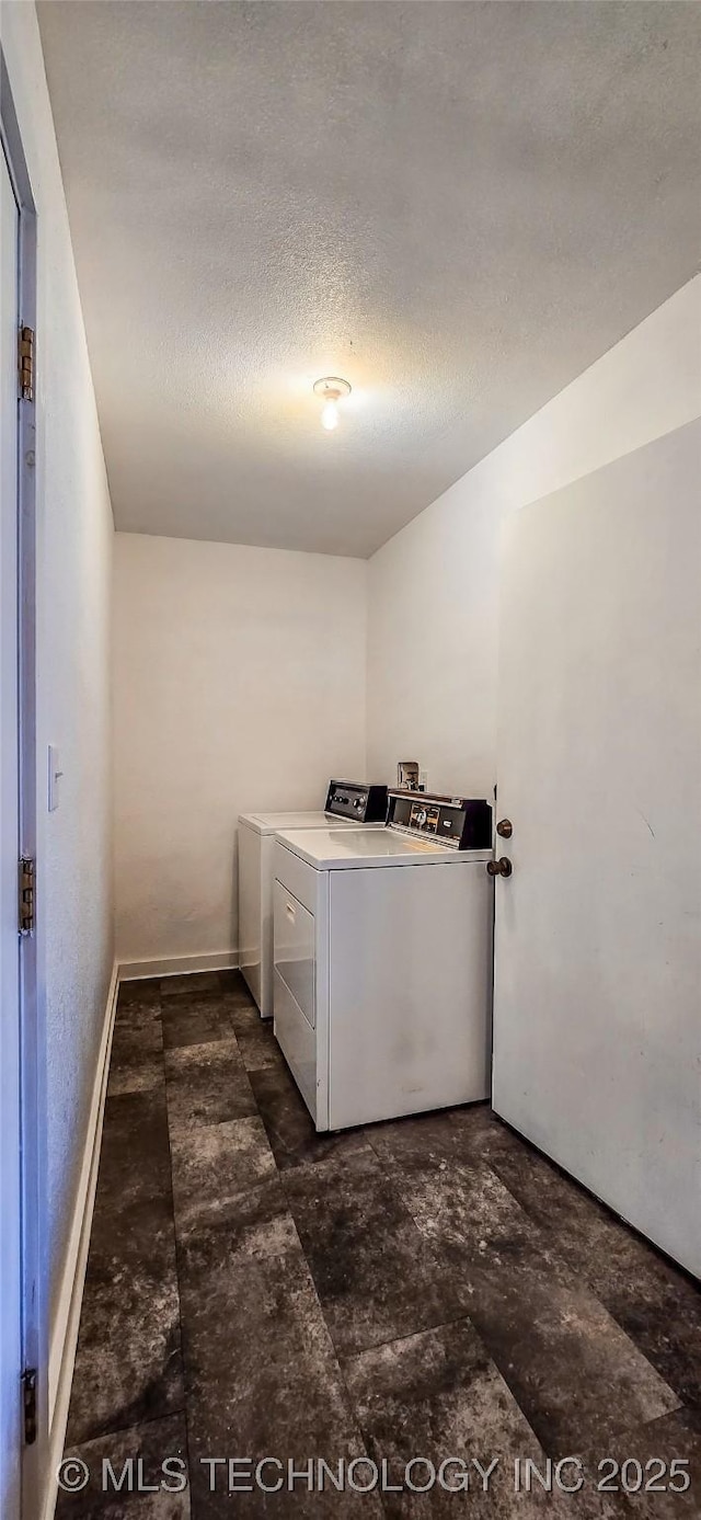 washroom featuring independent washer and dryer and a textured ceiling