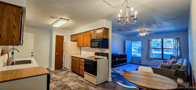 kitchen featuring ceiling fan with notable chandelier, sink, pendant lighting, and white appliances