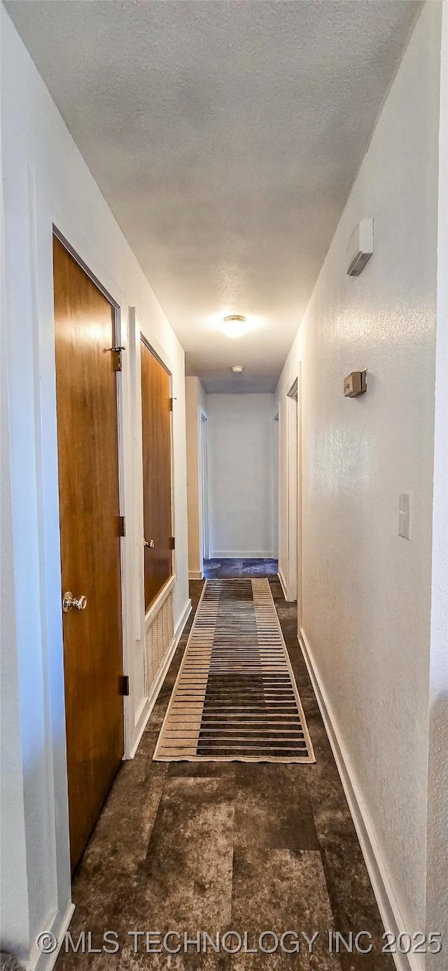 corridor featuring a textured ceiling