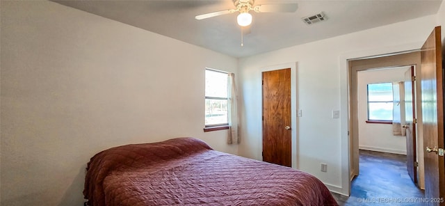 bedroom with ceiling fan and multiple windows