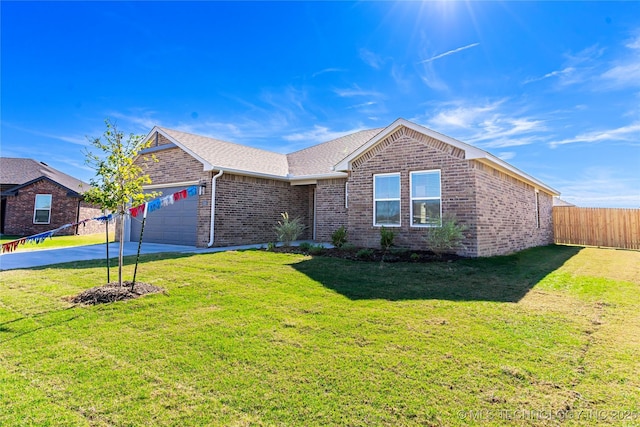 ranch-style house with a garage and a front lawn